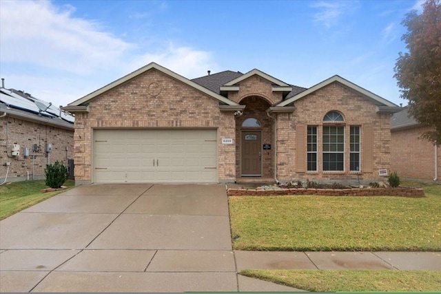 view of front of home with a garage and a front yard