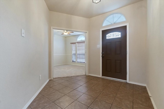 tiled entryway featuring ceiling fan