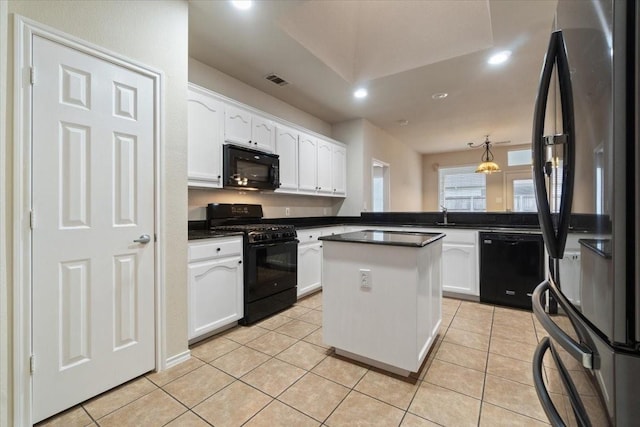 kitchen featuring black appliances, white cabinets, light tile patterned flooring, and a center island