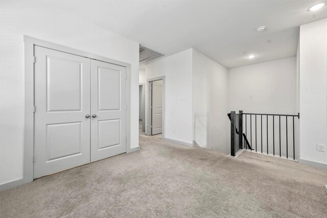 spare room with light colored carpet