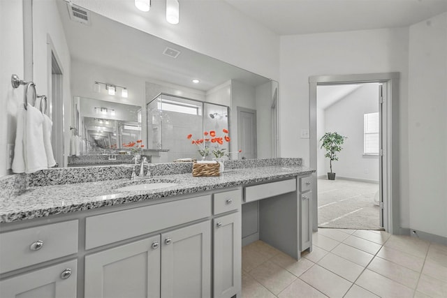 bathroom featuring vanity, a shower with shower door, and tile patterned flooring