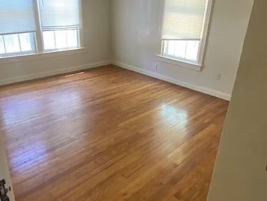 unfurnished room with hardwood / wood-style flooring