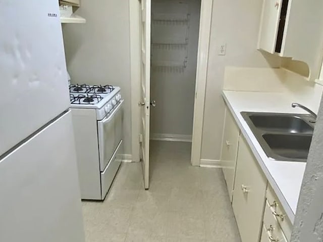 kitchen featuring white appliances and sink