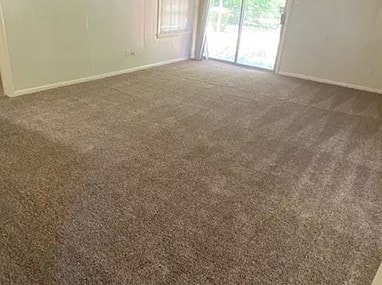 unfurnished room with dark carpet