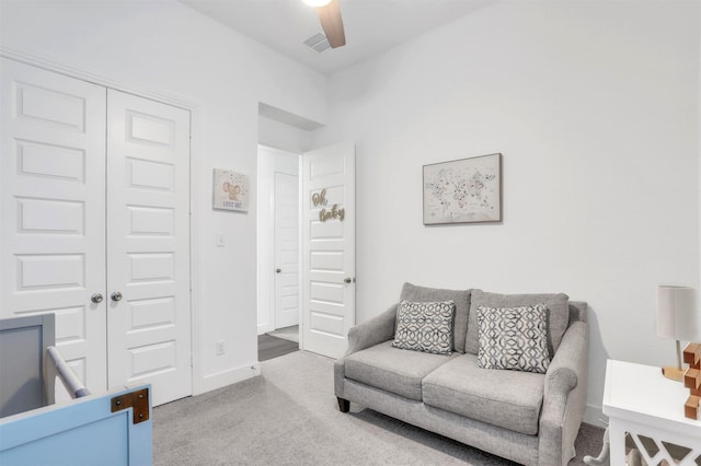 carpeted bedroom featuring ceiling fan and a closet