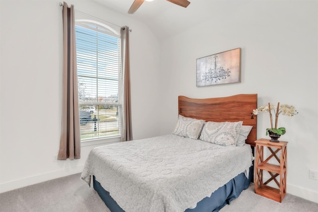 bedroom featuring ceiling fan, vaulted ceiling, and carpet flooring