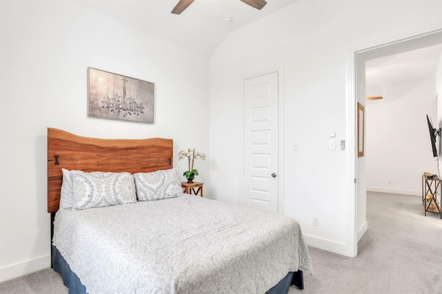 carpeted bedroom with ceiling fan and vaulted ceiling