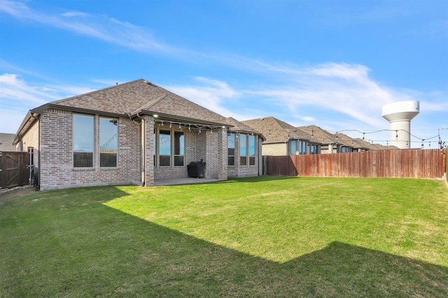 back of house featuring a yard