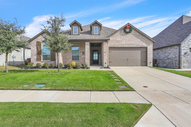 view of front facade with a front yard and a garage