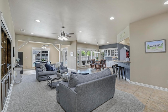 tiled living room with ceiling fan