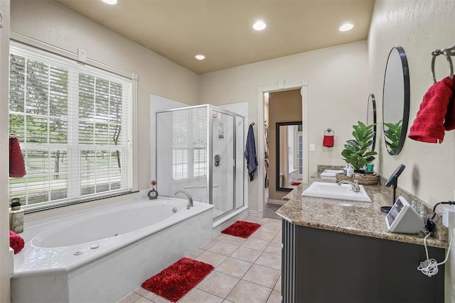 bathroom with tile patterned flooring, vanity, and independent shower and bath