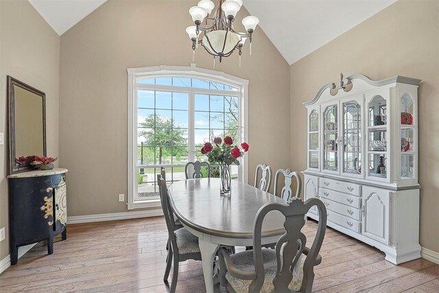 dining space featuring light hardwood / wood-style flooring, a chandelier, and plenty of natural light