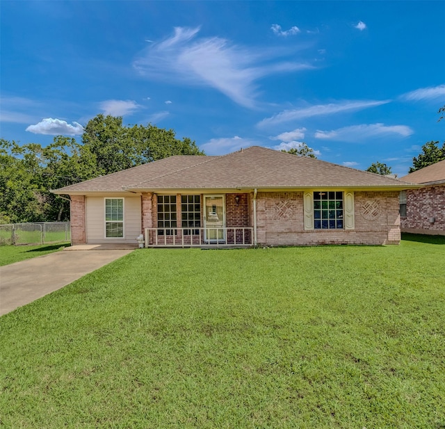 single story home featuring covered porch and a front yard