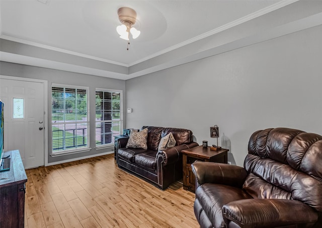 living room featuring light hardwood / wood-style flooring, ceiling fan, and crown molding