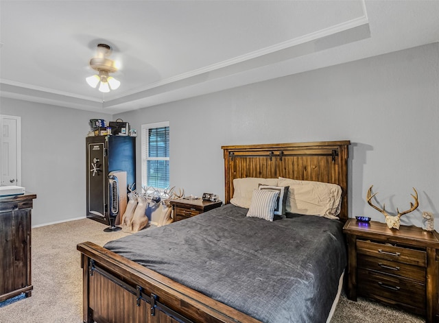 carpeted bedroom featuring a raised ceiling and ceiling fan