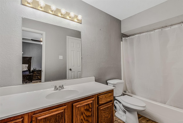 full bathroom with shower / bath combo, vanity, and toilet