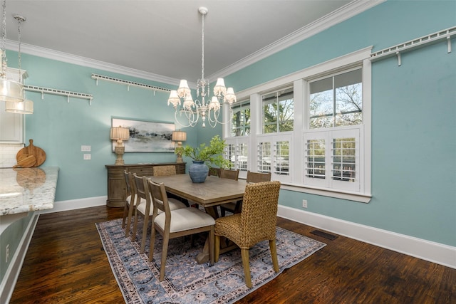 dining area featuring a chandelier, dark hardwood / wood-style flooring, and ornamental molding