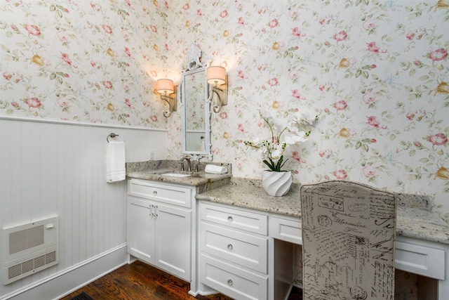 814 Barnes St, Mckinney, TX 75069 - bathroom featuring wallpapered walls, heating unit, wood finished floors, vanity, and a wainscoted wall