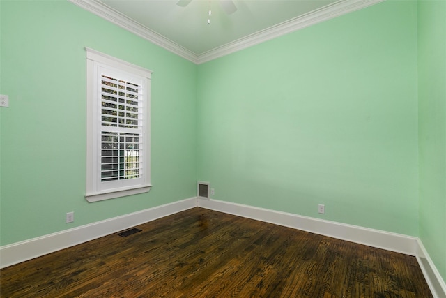 empty room featuring ceiling fan, crown molding, and dark wood-type flooring