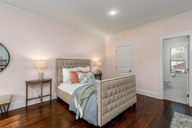 bedroom with dark hardwood / wood-style flooring, ornamental molding, and connected bathroom