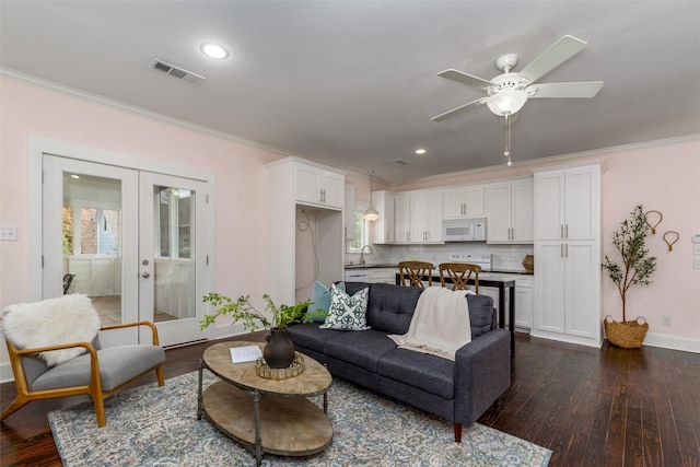 living room featuring ceiling fan, french doors, sink, dark hardwood / wood-style flooring, and crown molding