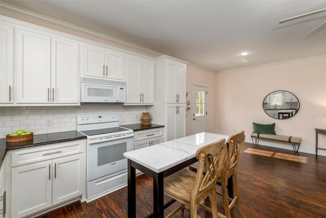 kitchen with white cabinetry, dark hardwood / wood-style floors, white appliances, and ornamental molding