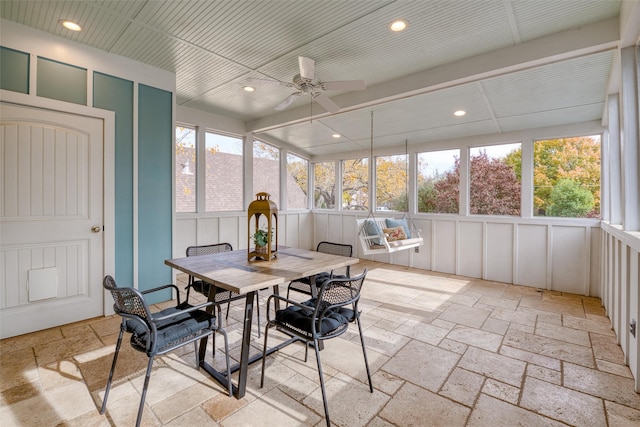 sunroom / solarium featuring ceiling fan and a healthy amount of sunlight