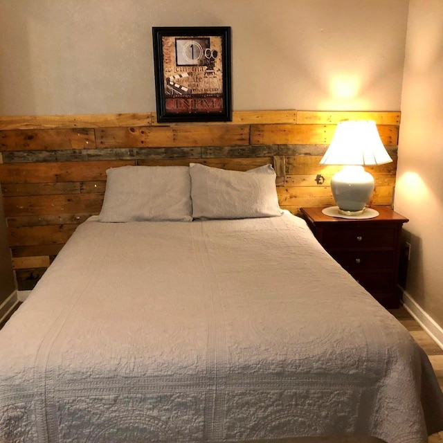 bedroom with hardwood / wood-style flooring