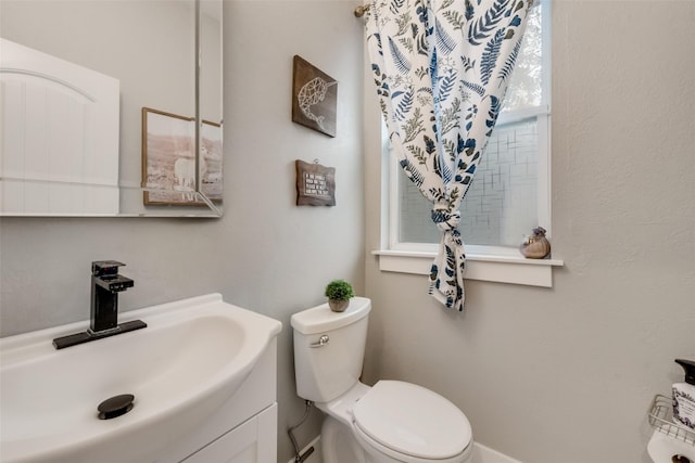 bathroom featuring vanity and toilet