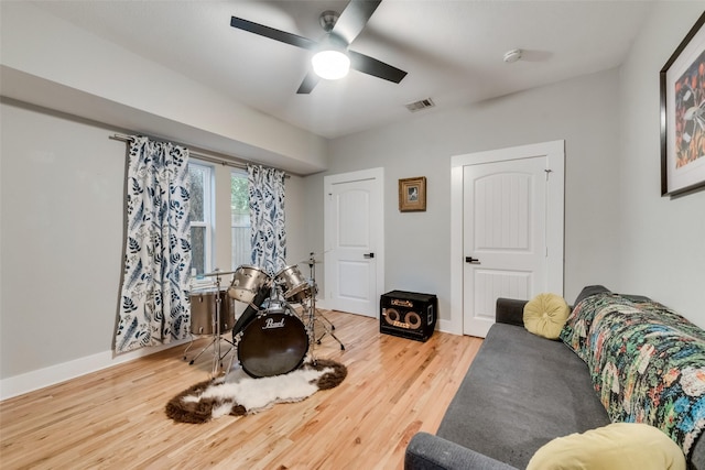 living area featuring ceiling fan and wood-type flooring