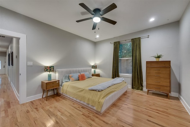 bedroom with ceiling fan and light hardwood / wood-style floors