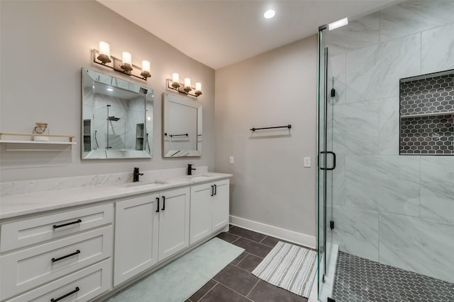 bathroom featuring tile patterned floors, vanity, and a shower with shower door