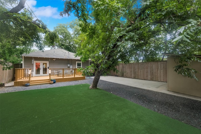 view of yard with french doors and a wooden deck