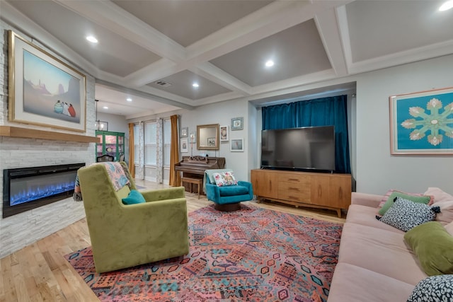 living room with beamed ceiling, hardwood / wood-style floors, a fireplace, and coffered ceiling