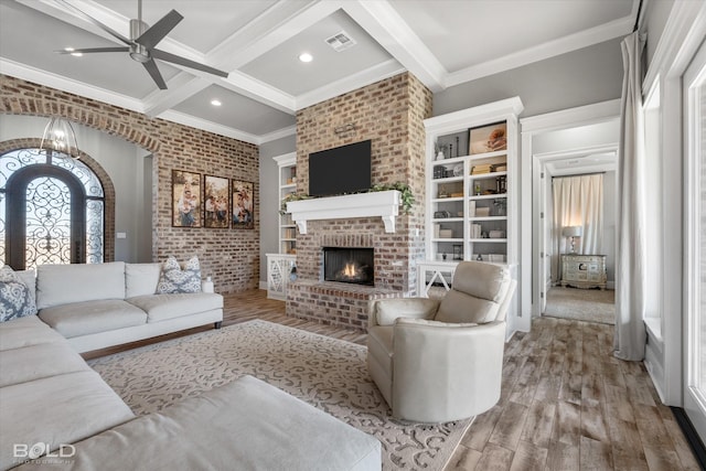 living room with beamed ceiling, ceiling fan, a fireplace, and light hardwood / wood-style flooring