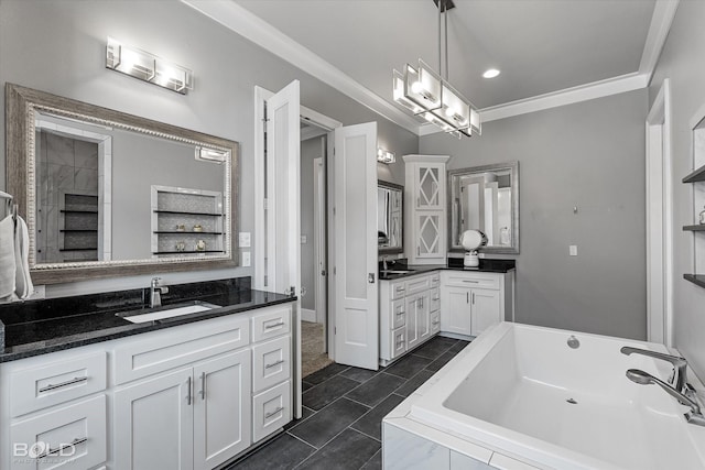 bathroom with ornamental molding, vanity, and a tub