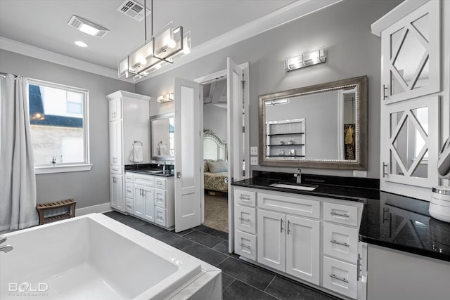 bathroom featuring tile patterned floors, vanity, ornamental molding, and tiled tub