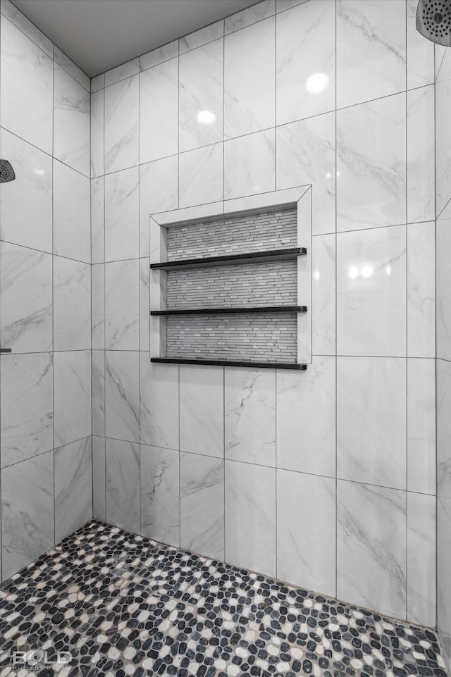 bathroom with a tile shower