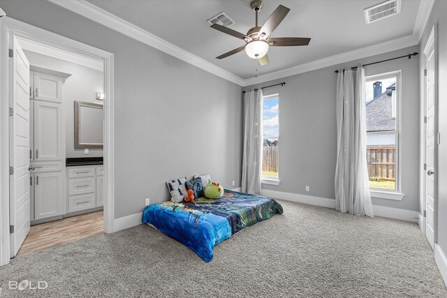 carpeted bedroom with multiple windows, ornamental molding, and ceiling fan