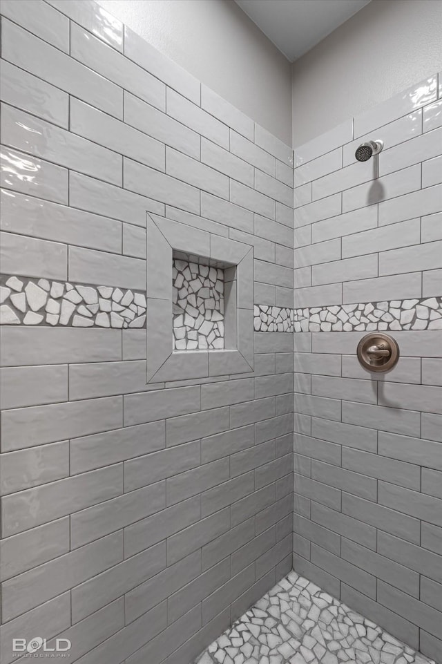 bathroom with a tile shower