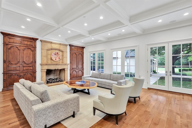 living room featuring french doors, light hardwood / wood-style floors, plenty of natural light, and beam ceiling