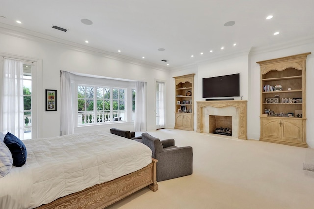 bedroom with carpet flooring, access to exterior, crown molding, and a fireplace