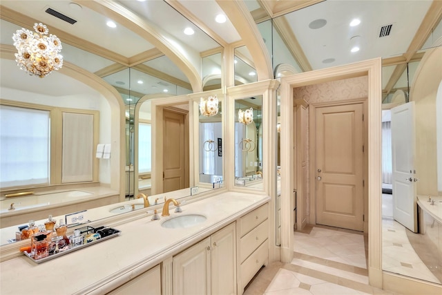 bathroom featuring a bathtub, vanity, ornamental molding, and an inviting chandelier