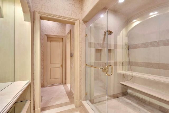 bathroom with an enclosed shower and tile patterned flooring