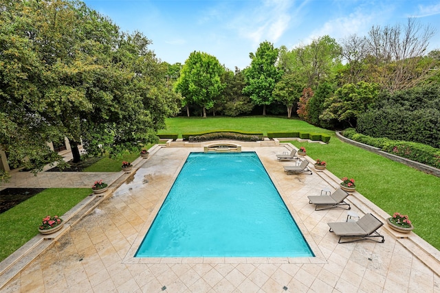 view of pool featuring a lawn, a patio area, and an in ground hot tub