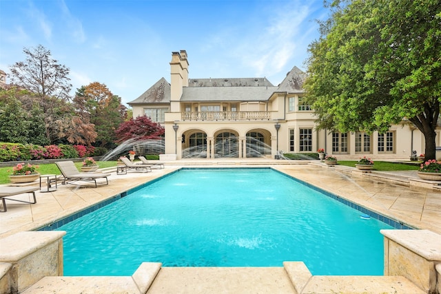 view of swimming pool featuring a patio area and pool water feature