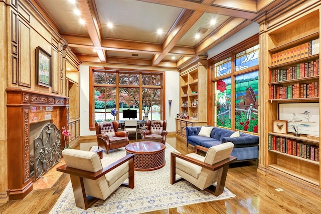 living area featuring coffered ceiling, built in features, light hardwood / wood-style flooring, beamed ceiling, and crown molding