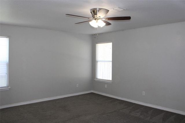 carpeted spare room with ceiling fan