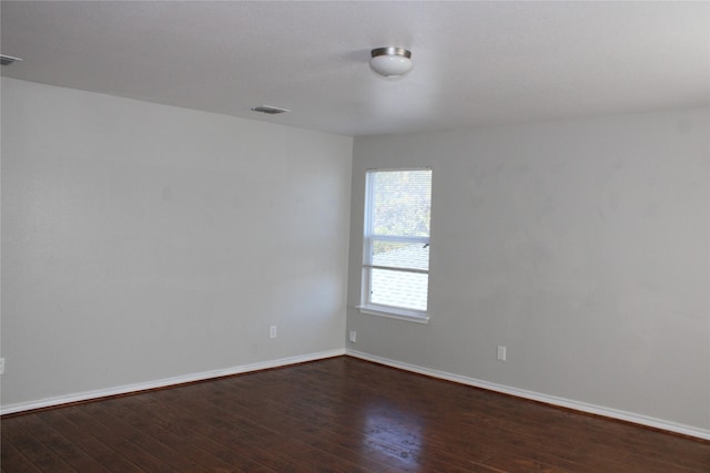 empty room with dark hardwood / wood-style floors