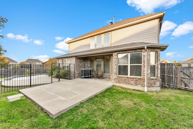 rear view of house with a yard and a patio